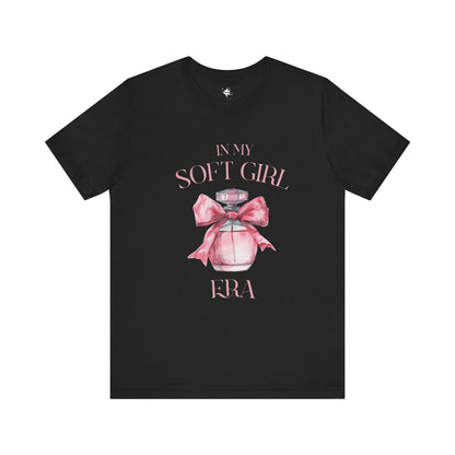 front of a black in my soft girl era t shirt with a pink perfume bottle with a pink bow