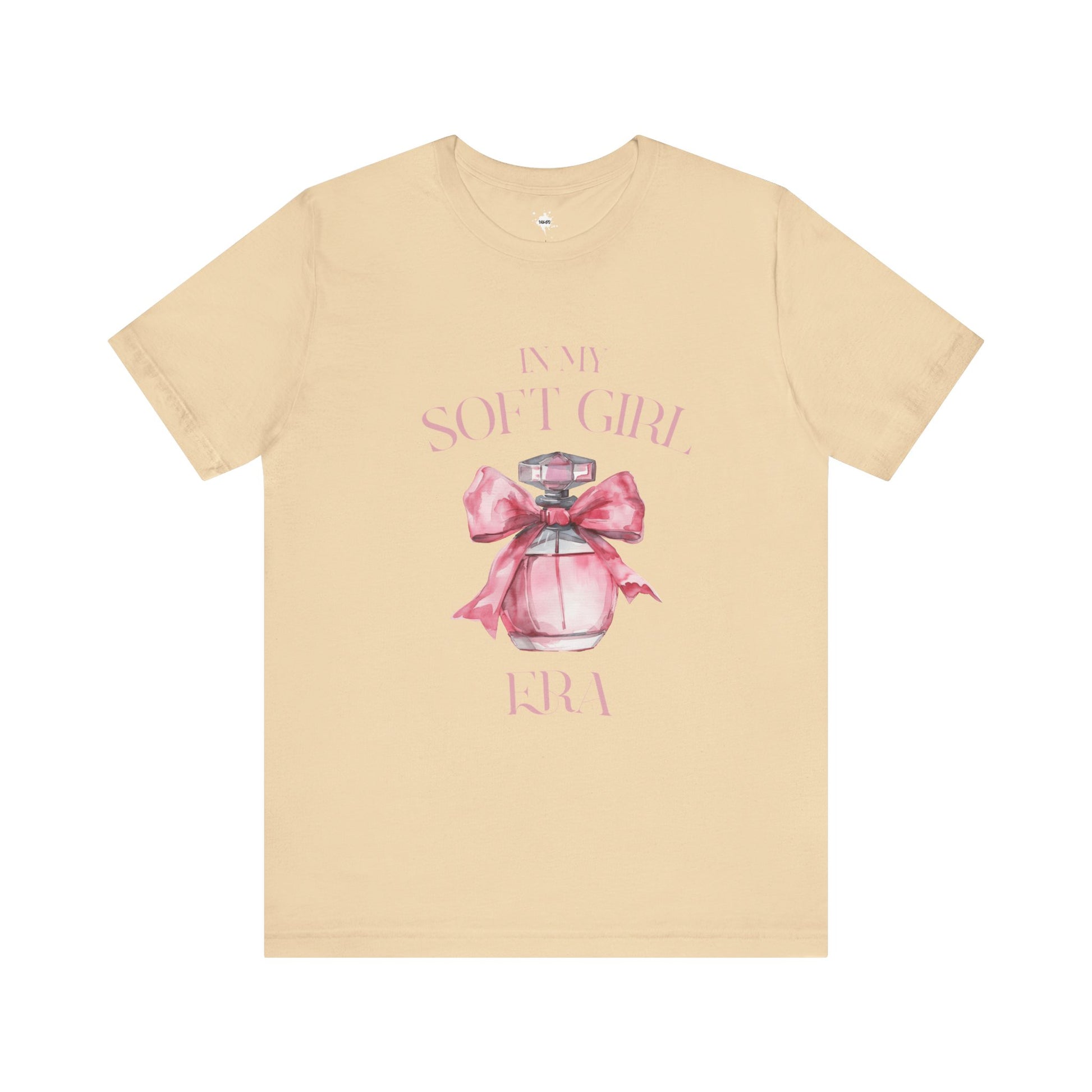 front of a cream in my soft girl era t shirt with a pink perfume bottle with a pink bow