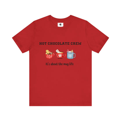 red t-shirt featuring three cups of hot chocolate and the phrase 'It's about the mug life,' perfect for cozy winter vibes and casual holiday style